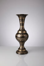 Decorative vase with intricate patterns on a textured surface