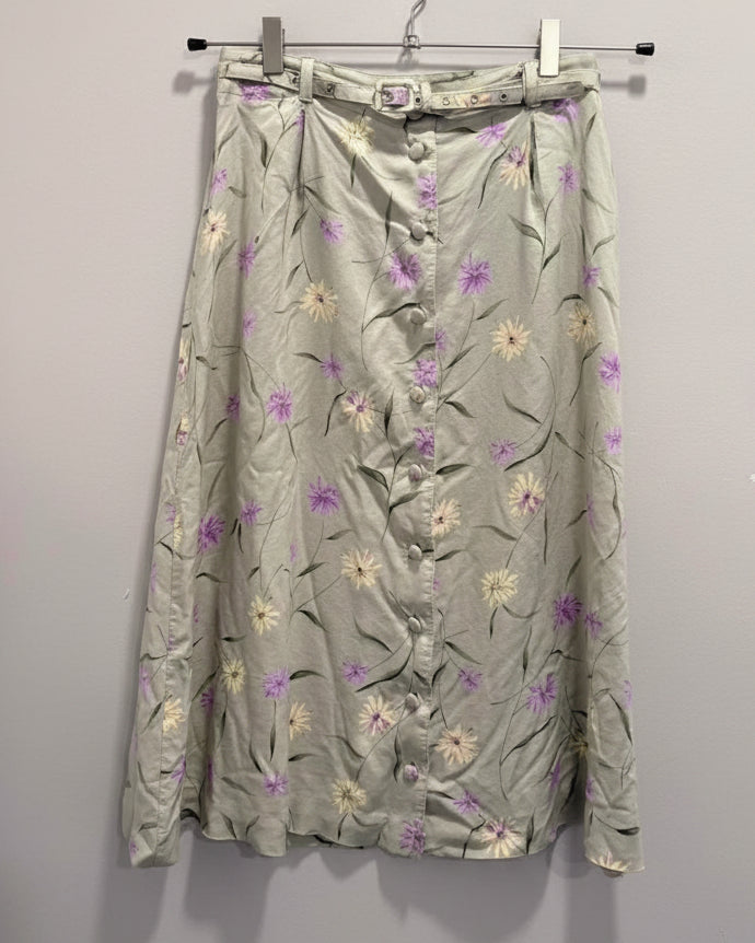 Floral patterned maxi skirt with buttons on a plain background