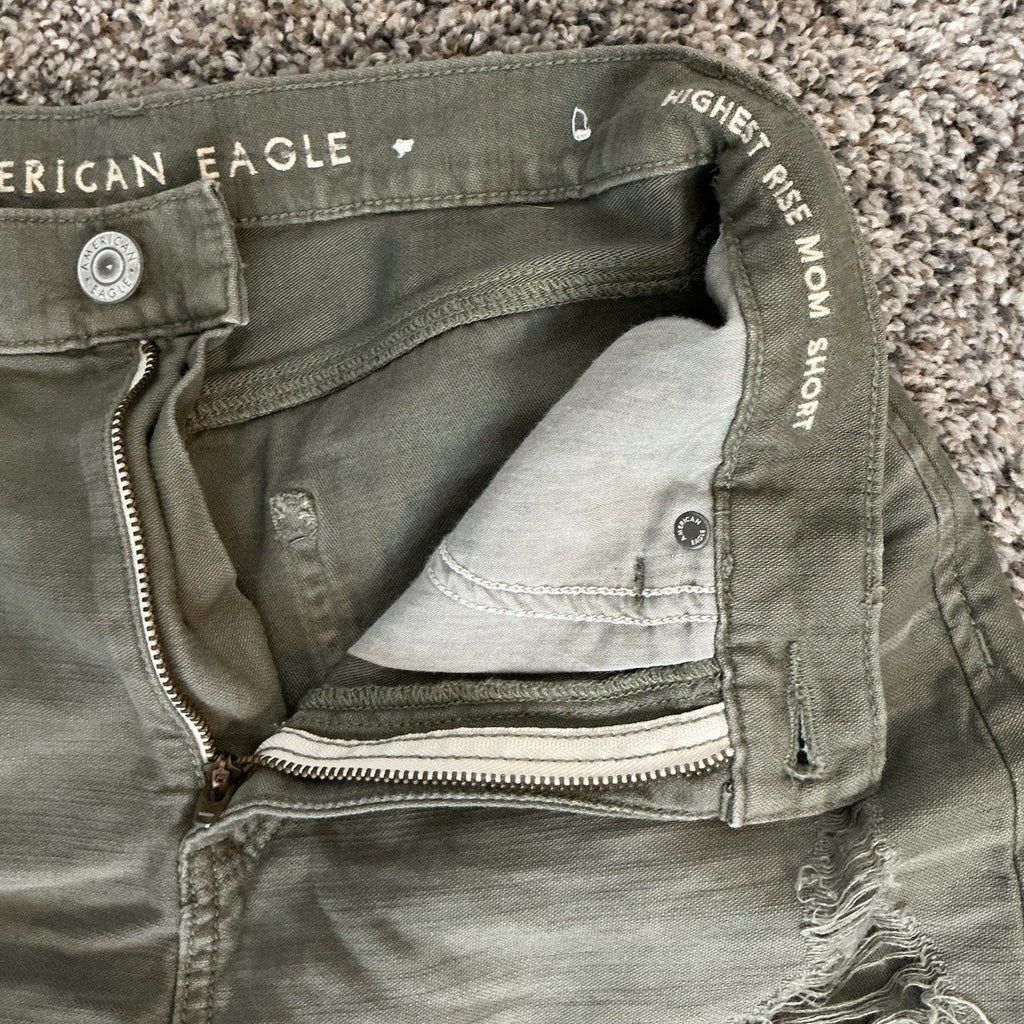 Green shorts with 'American Eagle' branding on a textured surface