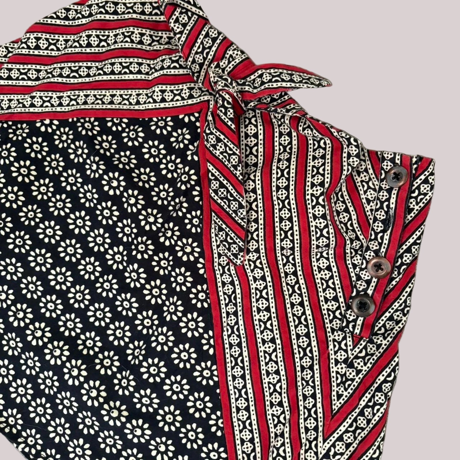 Mini fabric skirt with red, white, and black patterns on a white background