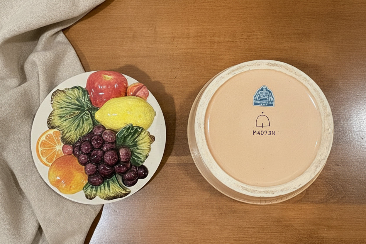 Round ceramic two piece fruit bowl and lid with a made in Japan vintage sticker and text on a wooden table