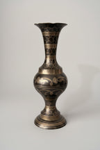 Decorative vase with intricate patterns on a textured surface