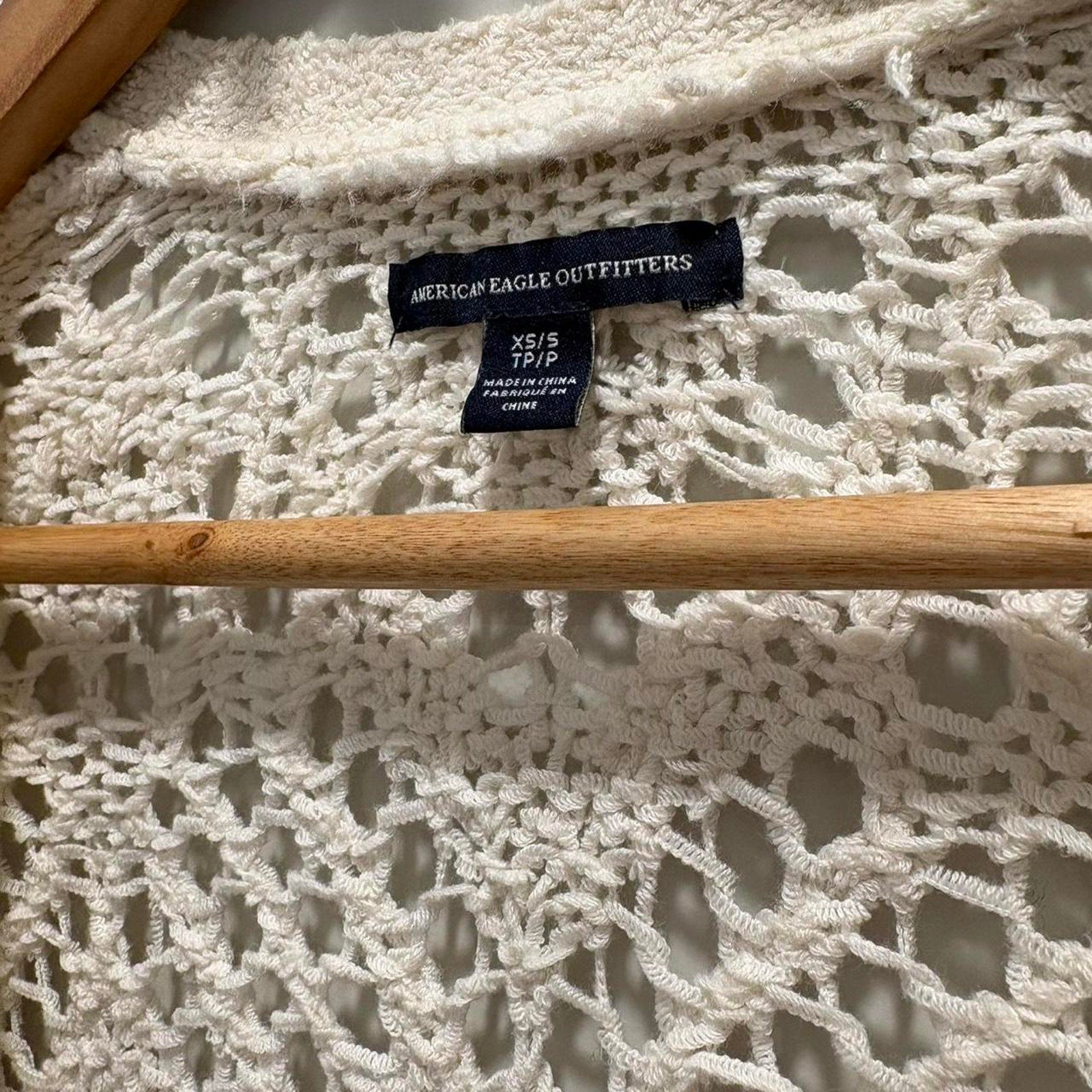 White crochet lace fabric with American Eagle Outfitters tag.