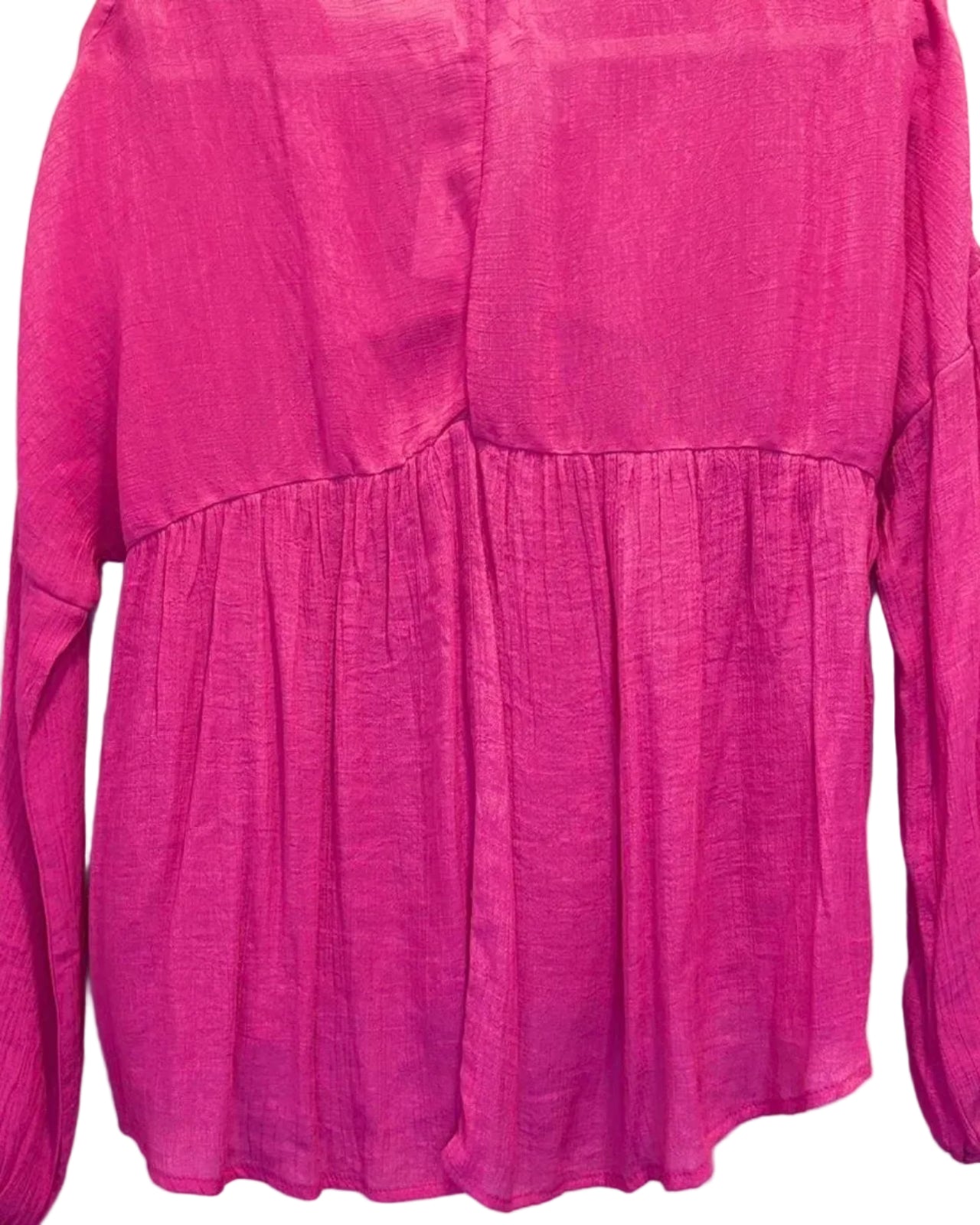 Back of pink flowy blouse on a white background