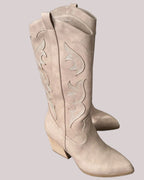 Pair of embroidered taupe cowboy boots on a light gray background.
