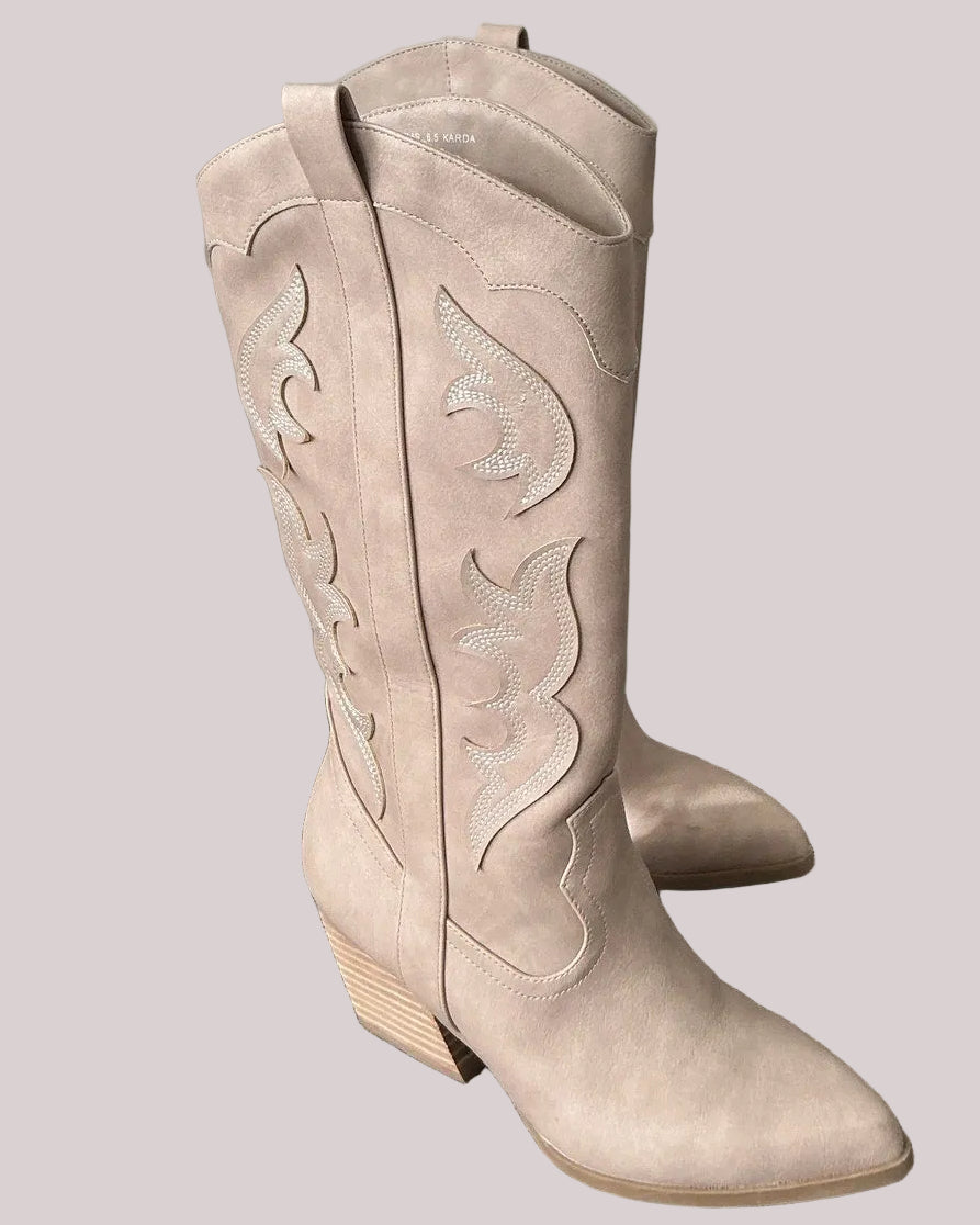 Pair of embroidered taupe cowboy boots on a light gray background.