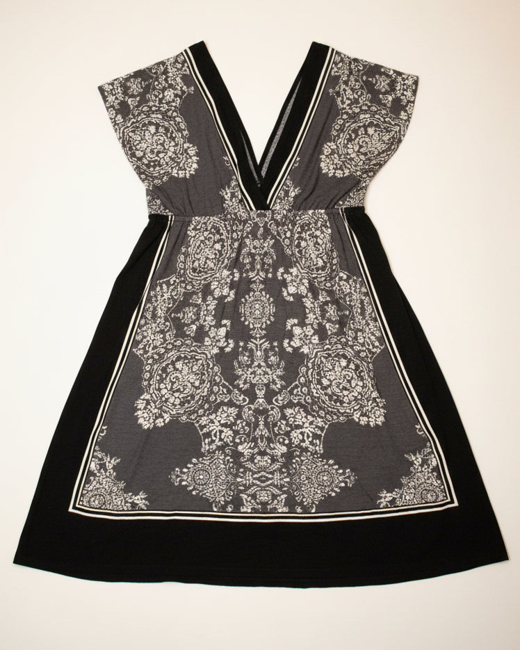 Black and white patterned dress on a neutral background