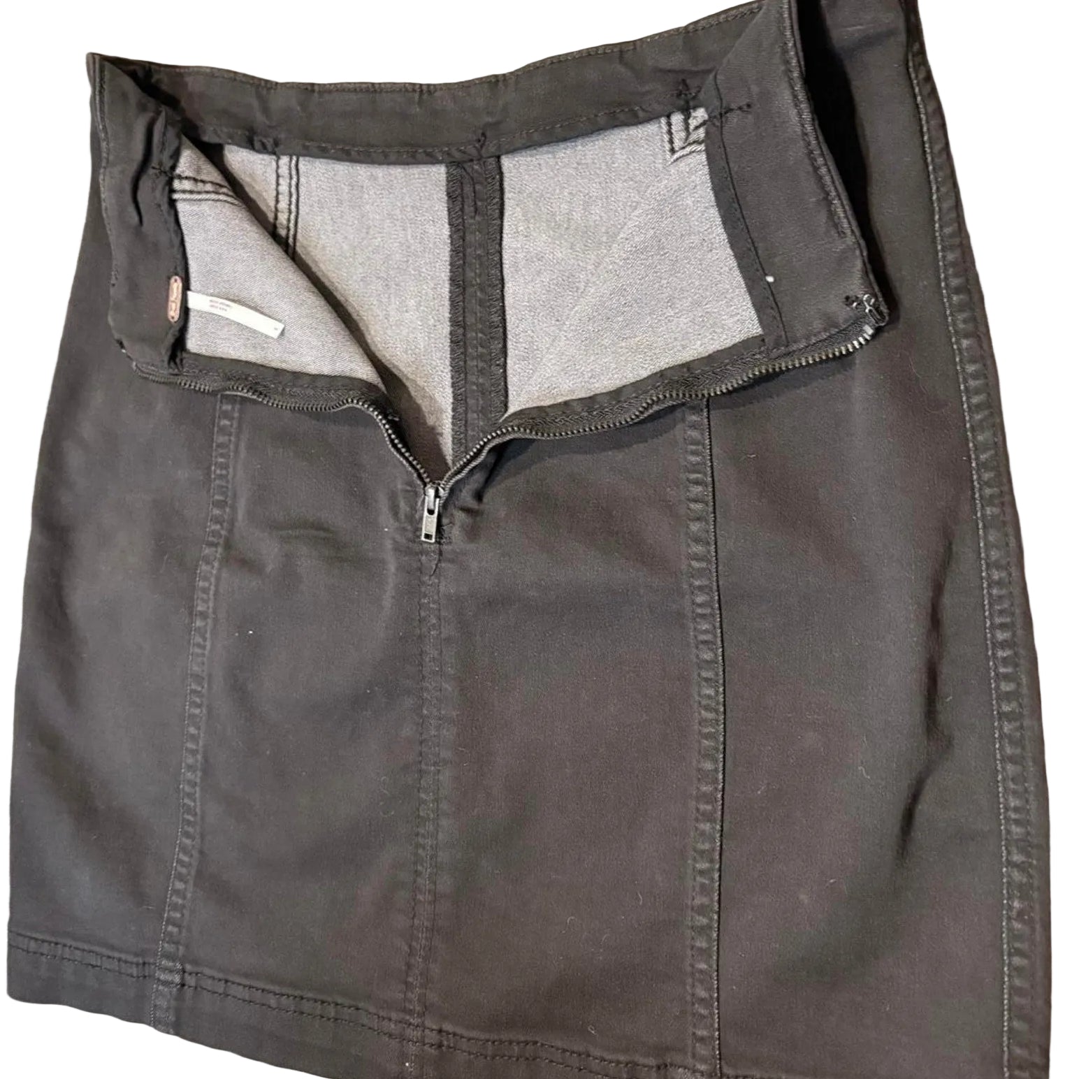 Back of a black denim mini skirt with an open zipper on a white background