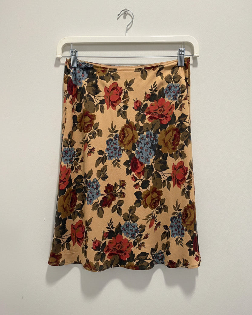 Floral patterned skirt hanging on a white background