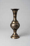 Decorative vase with intricate patterns on a textured surface