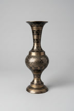 Decorative vase with intricate patterns on a textured surface