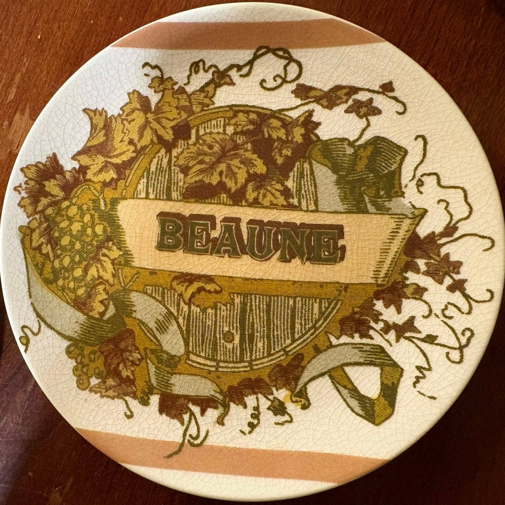 Vintage Pottery Barn small plate with 'Beaune' provincial design featuring grapes and a barrel on a wooden surface.