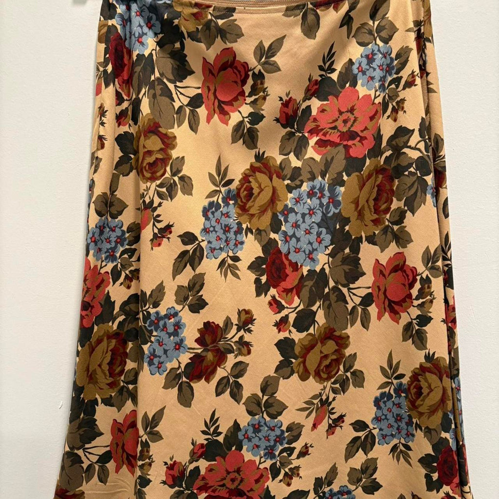 Floral patterned skirt with red, blue, and brown flowers on a beige background