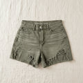Green denim fringe shorts with a 'American Eagle' label on a textured surface
