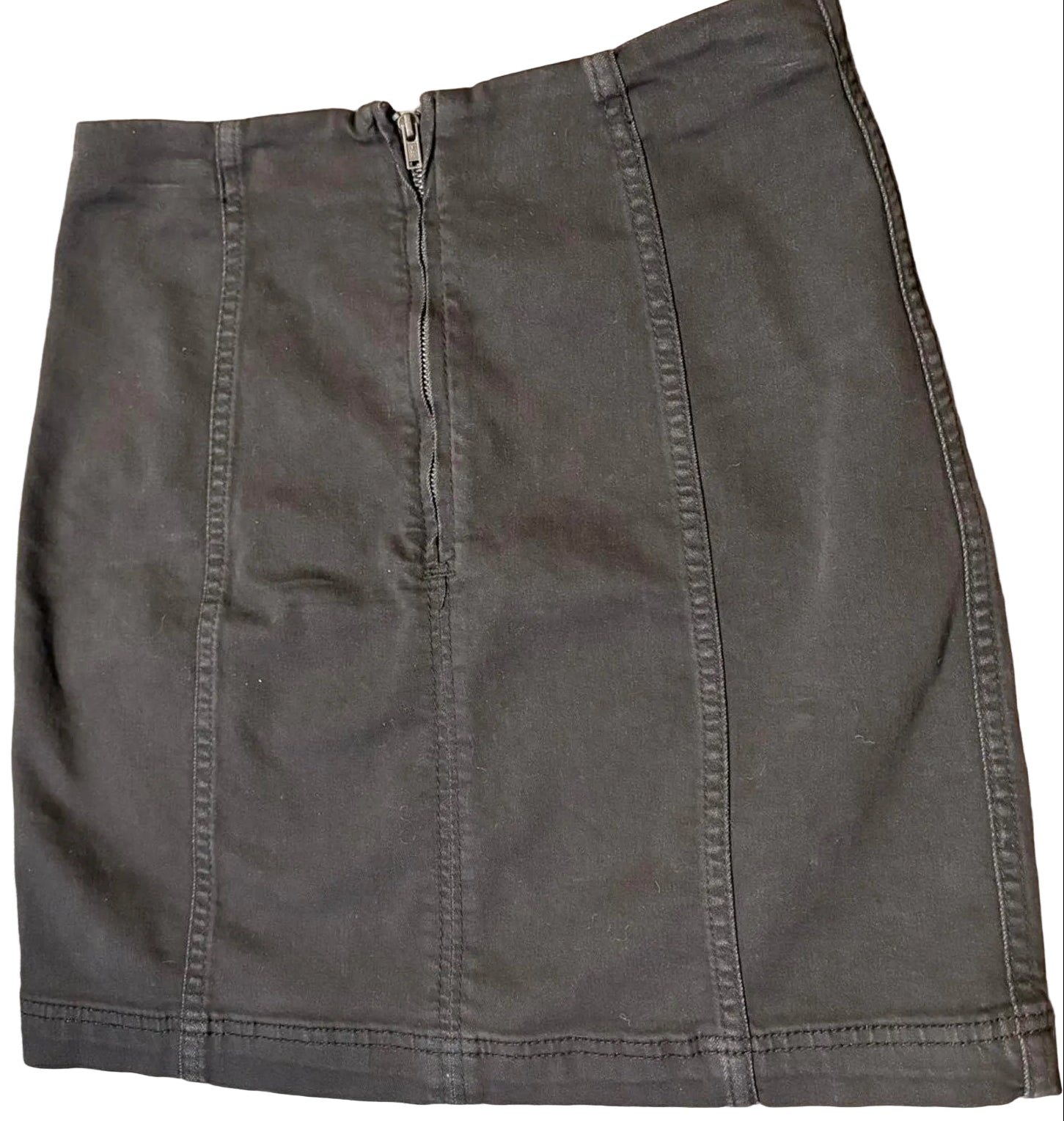 Back of a black denim mini skirt with zipper back on a white background.